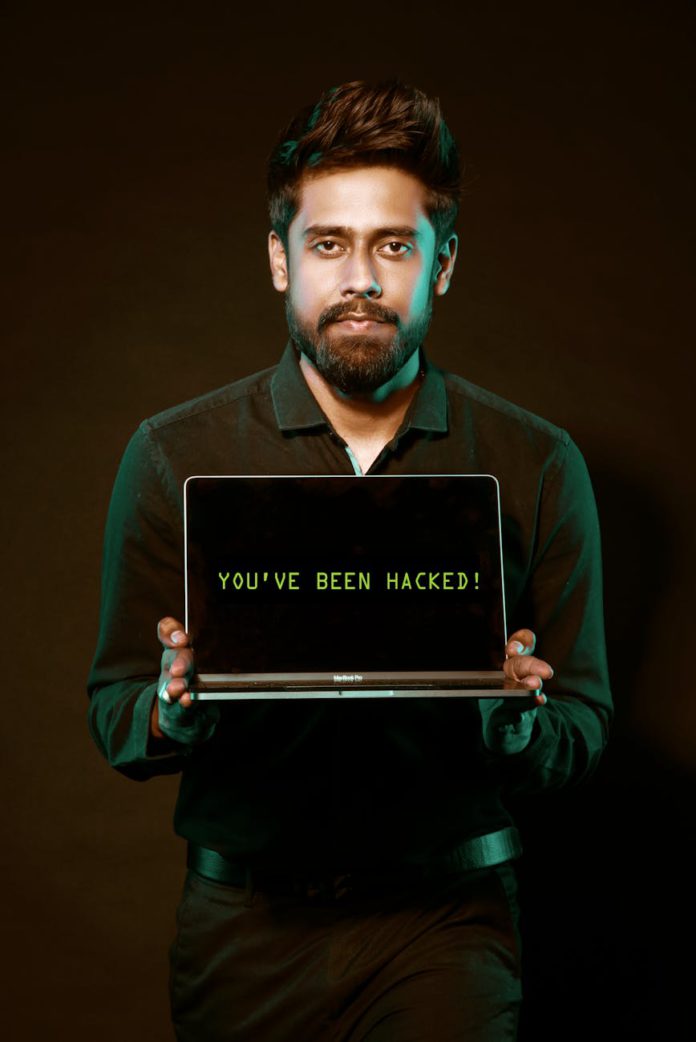 man holding laptop computer with both hands