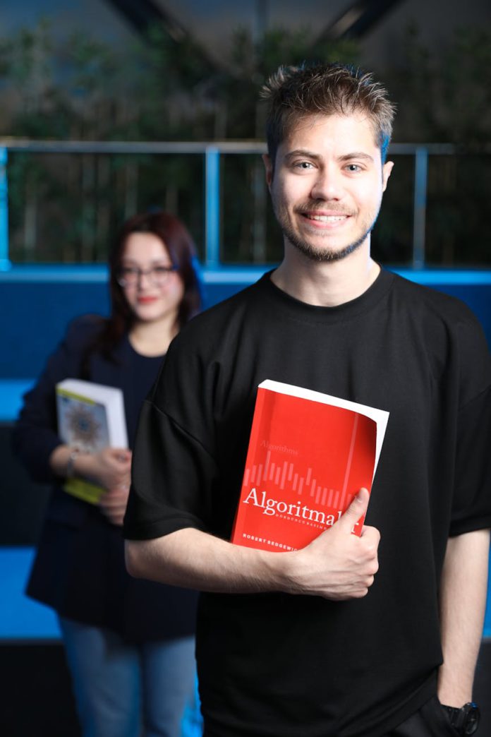 young professionals holding algorithm books